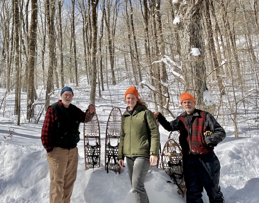 Bronson, Regan-Loomis, and Russ stand for a photo as they pack access trails to the sugarbush through deep snow in late February 2026.